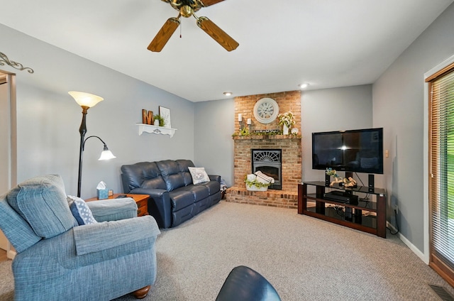 115 Deer Run Rd, Urbana, OH 43078 - carpeted living room featuring ceiling fan, a fireplace, and healthy amount of natural light