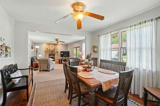 115 Deer Run Rd, Urbana, OH 43078 - dining room featuring a ceiling fan, a fireplace, and wood finished floors