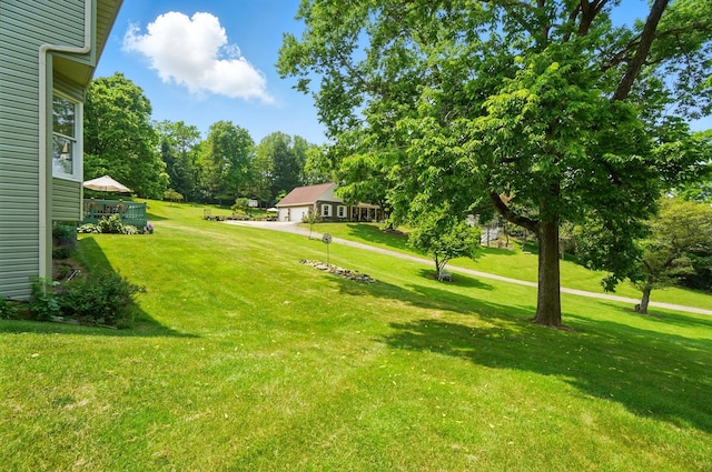 115 Deer Run Rd, Urbana, OH 43078 - view of green lawn featuring a garage and view of scattered trees