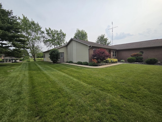 6708 Hillside Ct, Celina, OH 45822 - view of side of home with a lawn and brick siding
