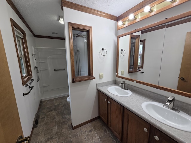 6708 Hillside Ct, Celina, OH 45822 - full bathroom with a textured ceiling, baseboards, double vanity, ornamental molding, and a shower