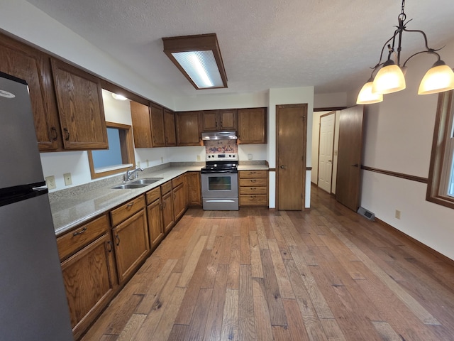 6708 Hillside Ct, Celina, OH 45822 - kitchen with appliances with stainless steel finishes, a sink, hardwood / wood-style floors, under cabinet range hood, and light countertops