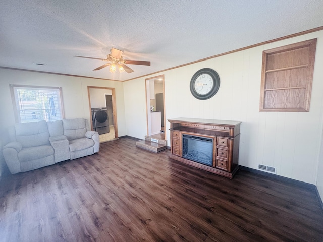 5319 Karafit Rd, Celina, OH 45822 - unfurnished living room featuring washer / clothes dryer, a textured ceiling, dark wood finished floors, a glass covered fireplace, and ceiling fan