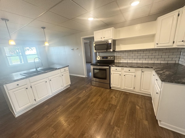 5319 Karafit Rd, Celina, OH 45822 - kitchen with stainless steel appliances, white cabinets, dark wood-style flooring, backsplash, and a paneled ceiling