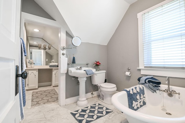 full bathroom featuring baseboards, a soaking tub, marble finish floor, and vaulted ceiling