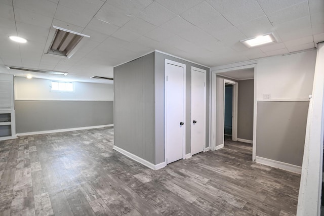 basement featuring baseboards and wood finished floors