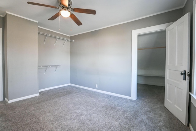 unfurnished bedroom with a closet, carpet flooring, crown molding, and baseboards