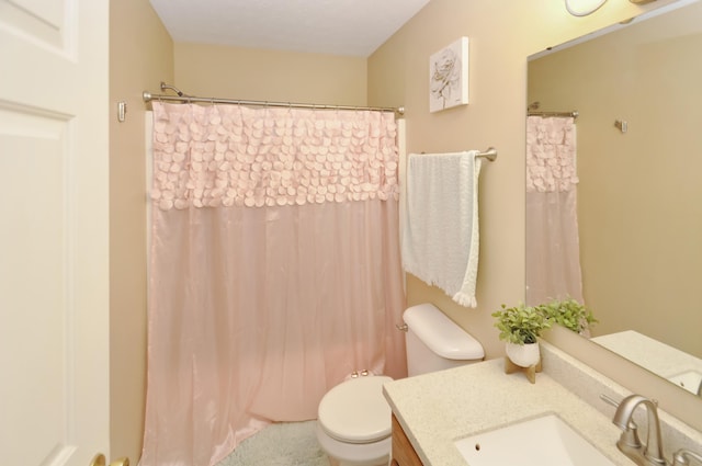 bathroom featuring toilet, a shower with shower curtain, and vanity