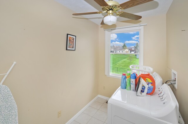 washroom featuring separate washer and dryer, baseboards, light tile patterned floors, a ceiling fan, and laundry area