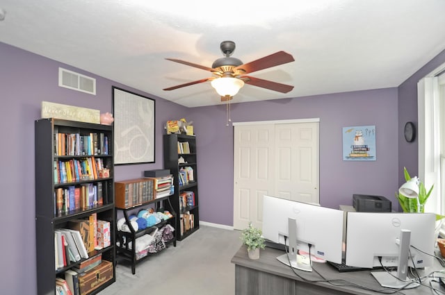 home office with visible vents, baseboards, a ceiling fan, and carpet flooring