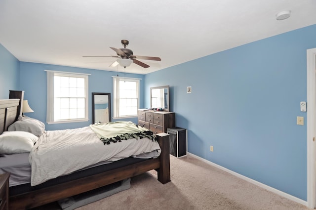carpeted bedroom with baseboards and a ceiling fan