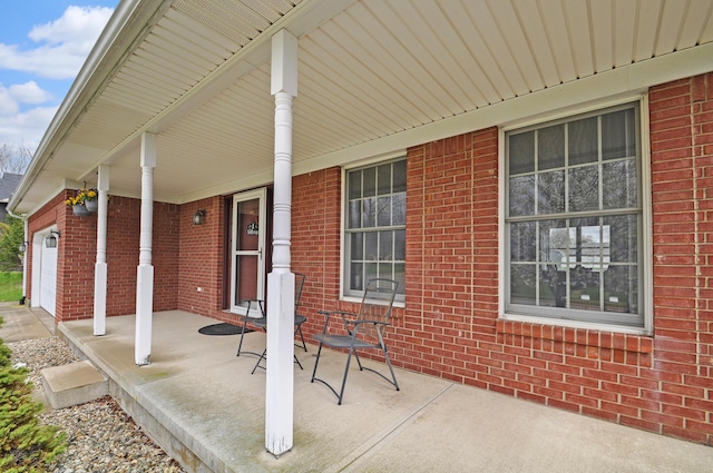 view of patio featuring covered porch and a garage
