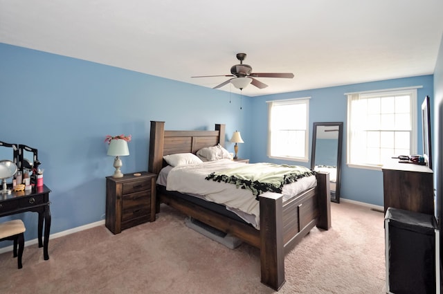 bedroom with baseboards, a ceiling fan, and light colored carpet