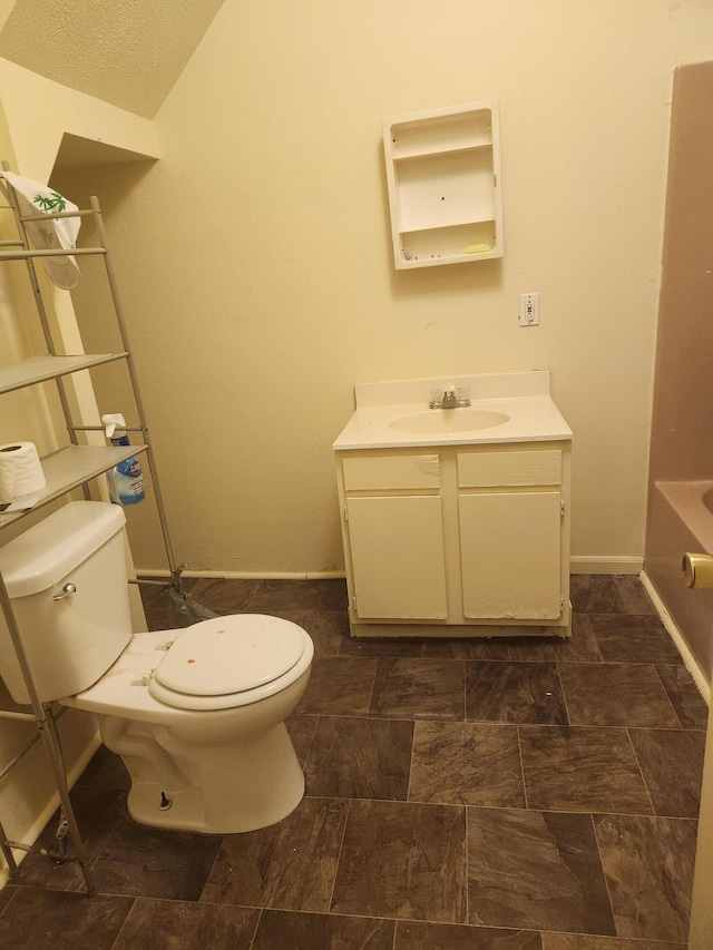 411-413 Water St, Connersville, IN 47331 - bathroom with toilet, vanity, a tub to relax in, and baseboards