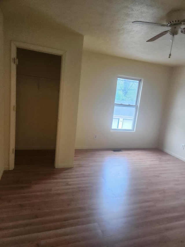 411-413 Water St, Connersville, IN 47331 - unfurnished bedroom featuring wood finished floors, a closet, a ceiling fan, and baseboards