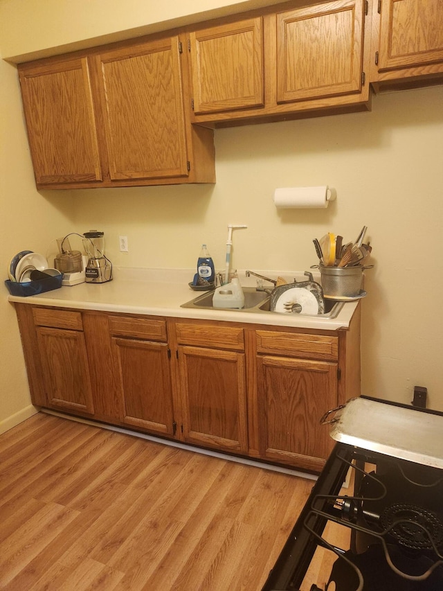 411-413 Water St, Connersville, IN 47331 - kitchen with light countertops, light wood-type flooring, and brown cabinets