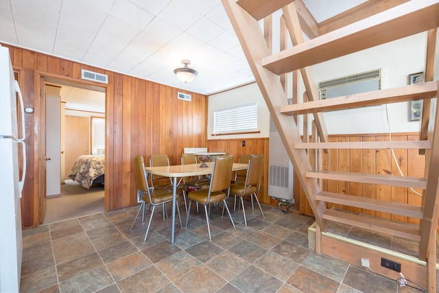 7535 Township Rd 269, Russells Point, OH 43348 - dining room with wood walls, stone finish flooring, and a heating unit
