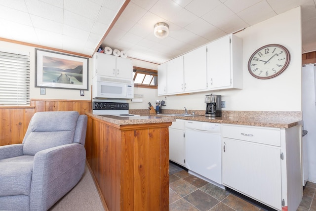 7535 Township Rd 269, Russells Point, OH 43348 - kitchen with white appliances, white cabinetry, wooden walls, wainscoting, and dark stone finish flooring