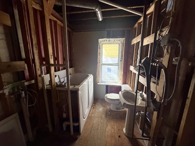 8030 State Route 41, Troy, OH 45373 - full bathroom with independent washer and dryer, toilet, a bath, and wood-type flooring