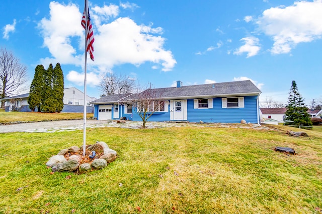 single story home featuring a front yard, driveway, and an attached garage