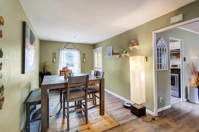 dining room featuring wood finished floors and baseboards