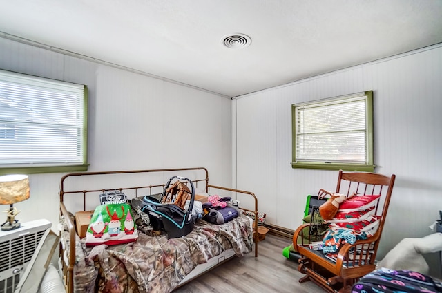 bedroom with wood finished floors and visible vents