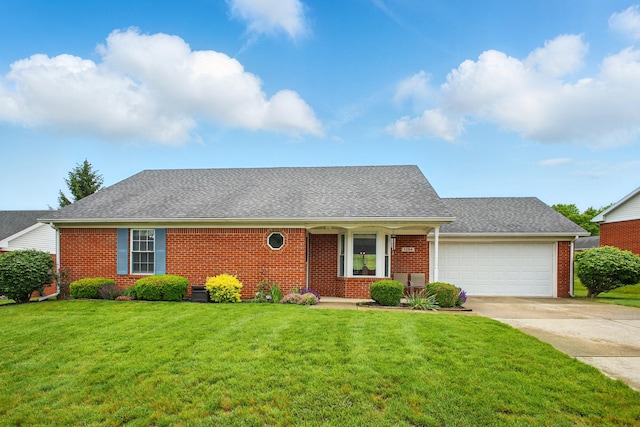 1264 Pheasant Run Unit 74, Springfield, OH 45503 - view of front of home with brick siding, an attached garage, driveway, and a front lawn