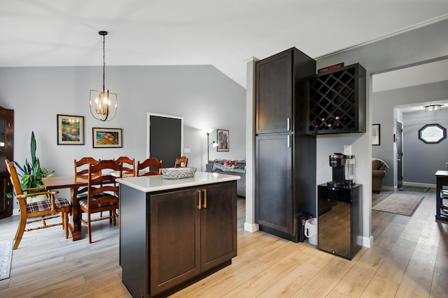 1264 Pheasant Run Unit 74, Springfield, OH 45503 - kitchen with lofted ceiling, light wood finished floors, a kitchen island, a chandelier, and light countertops