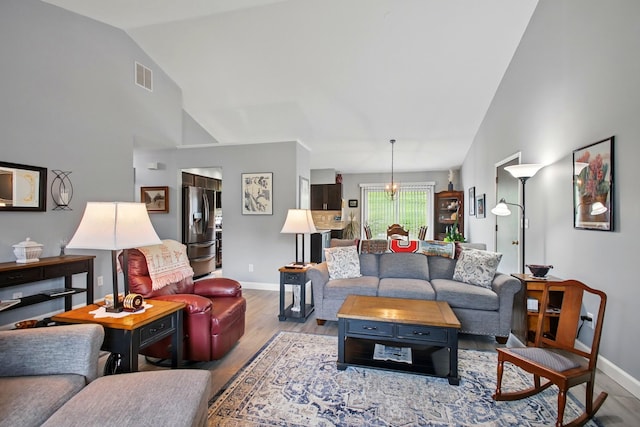 1264 Pheasant Run Unit 74, Springfield, OH 45503 - living room featuring wood finished floors, baseboards, and high vaulted ceiling