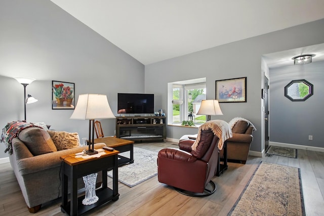 1264 Pheasant Run Unit 74, Springfield, OH 45503 - living room featuring high vaulted ceiling, baseboards, and light wood-style flooring