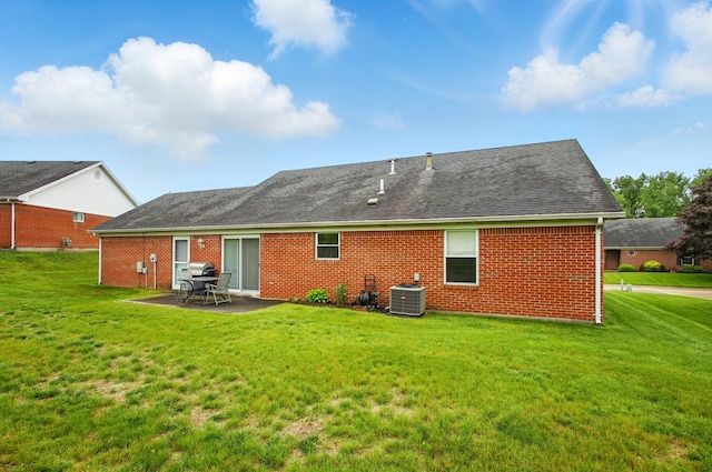 1264 Pheasant Run Unit 74, Springfield, OH 45503 - rear view of house with cooling unit, brick siding, a patio, and a yard