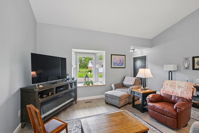 1264 Pheasant Run Unit 74, Springfield, OH 45503 - living area with wood finished floors, vaulted ceiling, and baseboards