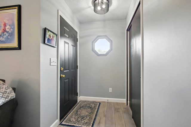 1264 Pheasant Run Unit 74, Springfield, OH 45503 - entryway with light wood-style flooring, baseboards, and a textured ceiling