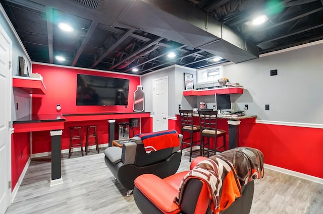 1087 Ayrshire Dr, Columbus, OH 43207 - recreation room with wood finished floors, baseboards, and a bar