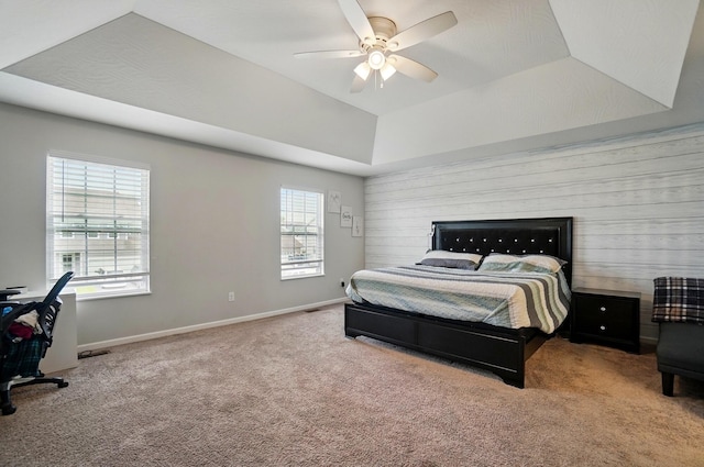 1087 Ayrshire Dr, Columbus, OH 43207 - bedroom featuring carpet, a raised ceiling, baseboards, a ceiling fan, and wood walls