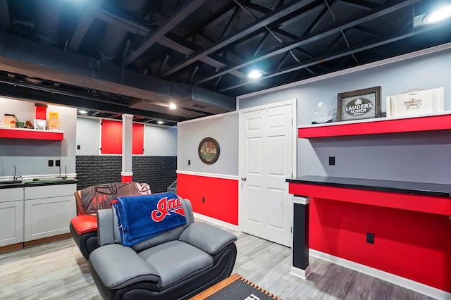 1087 Ayrshire Dr, Columbus, OH 43207 - playroom featuring light wood-type flooring, bar area, and baseboards