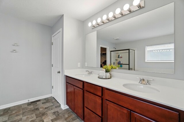 1087 Ayrshire Dr, Columbus, OH 43207 - full bath featuring a stall shower, double vanity, baseboards, and a spacious closet