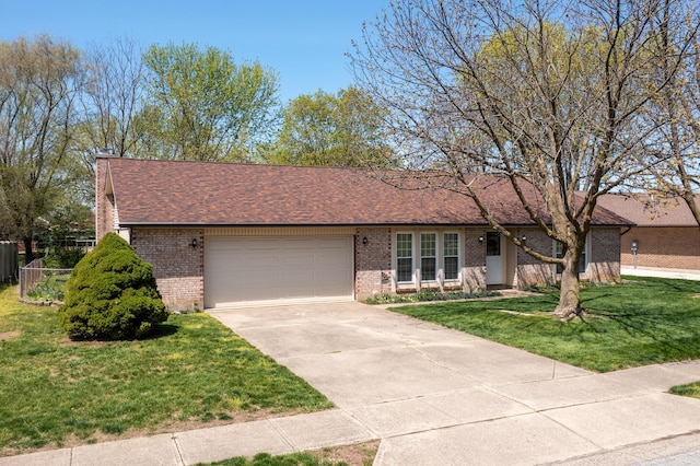 single story home featuring a front lawn, fence, brick siding, an attached garage, and driveway