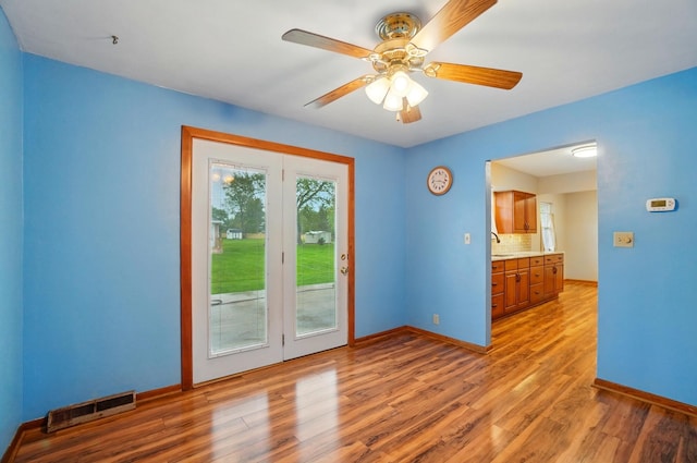 70 Helen St, Enon, OH 45323 - unfurnished room with wood finished floors, ceiling fan, baseboards, and a sink