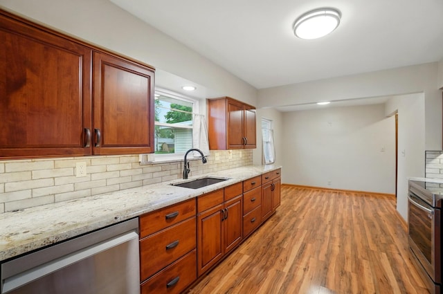 70 Helen St, Enon, OH 45323 - kitchen featuring stainless steel appliances, a sink, decorative backsplash, and light wood-type flooring