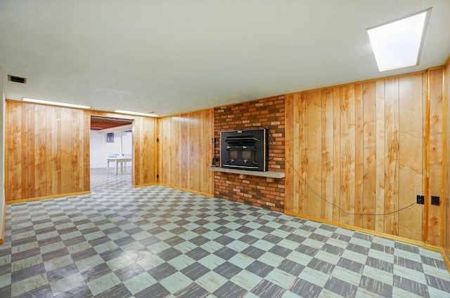 70 Helen St, Enon, OH 45323 - unfurnished living room featuring wood walls, tile patterned floors, a fireplace, and baseboards