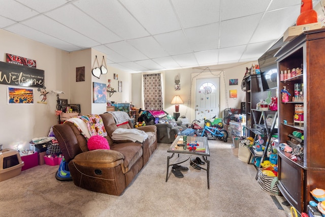 carpeted living room with a paneled ceiling