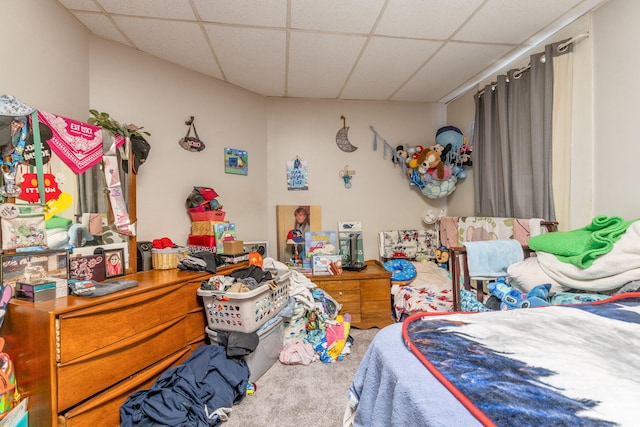 bedroom featuring carpet flooring and a paneled ceiling