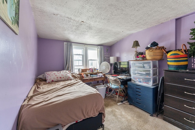 bedroom with a textured ceiling and carpet flooring