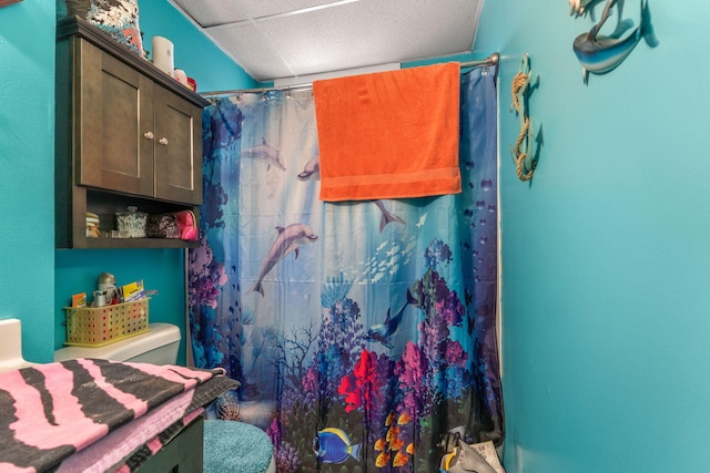 bathroom with toilet and a shower with curtain