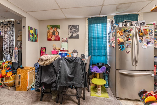 interior space with a drop ceiling and carpet