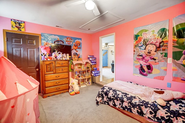 bedroom featuring attic access, carpet, visible vents, and ceiling fan