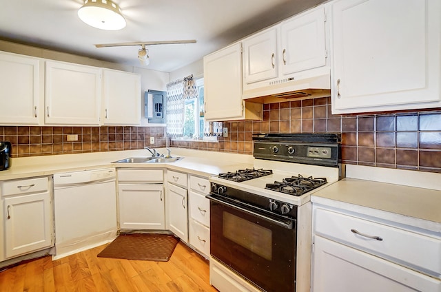 kitchen featuring decorative backsplash, range with gas stovetop, dishwasher, under cabinet range hood, and a sink