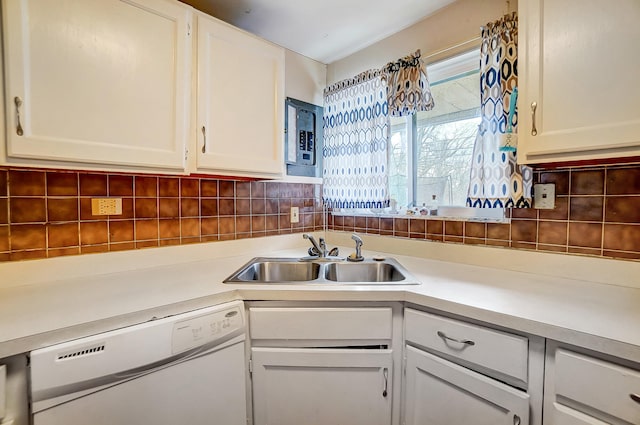 kitchen with tasteful backsplash, light countertops, a sink, and dishwasher