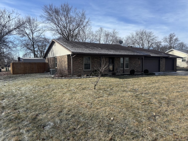 ranch-style house featuring cooling unit, a garage, and a front lawn